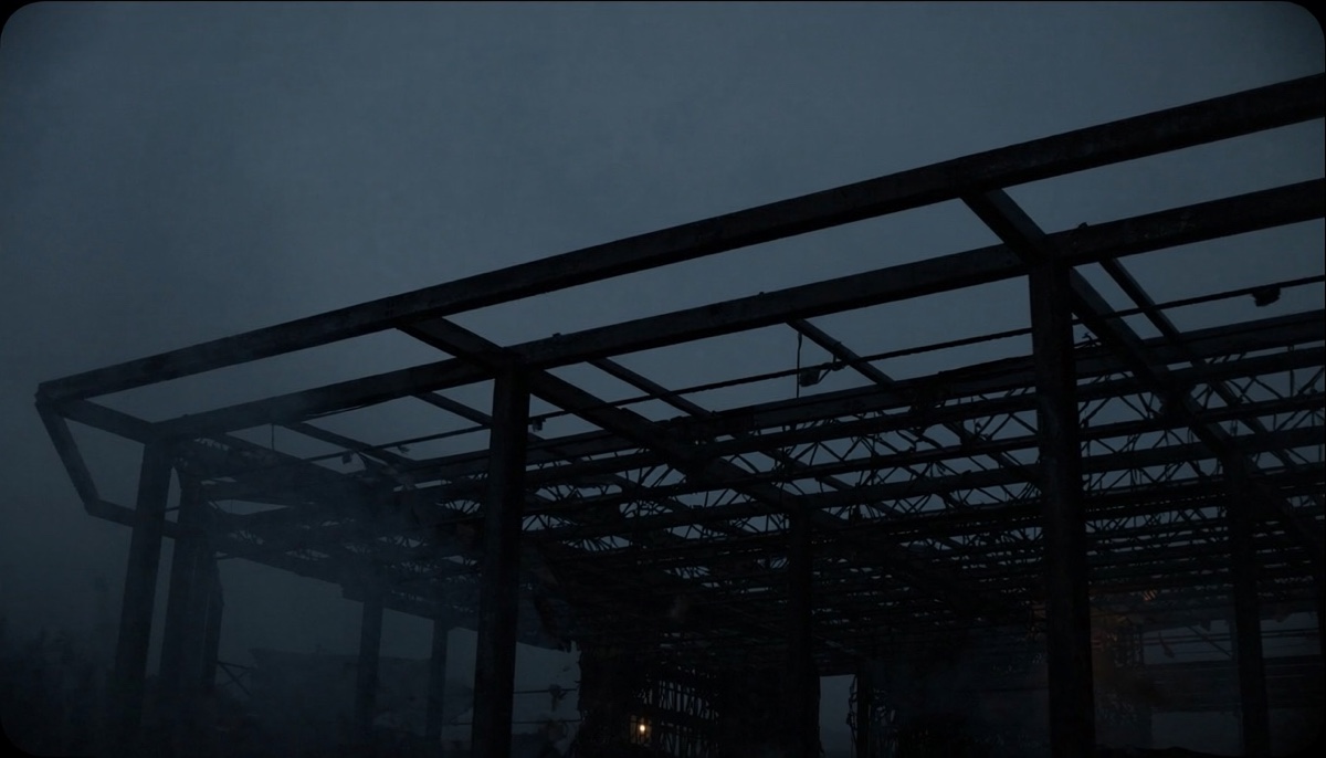 Exposed structural steel skeleton of an unfinished building at twilight — visual metaphor for AI as architecture rather than facade.